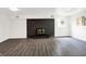Finished basement featuring wood-look vinyl flooring and black painted brick fireplace at 9157 Neptune Dr, Indianapolis, IN 46229