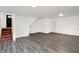 Finished basement with access to stairs and gray wood-look flooring at 9157 Neptune Dr, Indianapolis, IN 46229