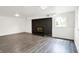 Finished basement featuring a brick fireplace and gray wood-look floors at 9157 Neptune Dr, Indianapolis, IN 46229