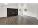 Spacious finished basement with wood-look vinyl flooring and a black painted brick fireplace at 9157 Neptune Dr, Indianapolis, IN 46229
