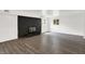 Finished basement with wood-look vinyl flooring, black painted brick fireplace, and natural light at 9157 Neptune Dr, Indianapolis, IN 46229