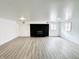 Spacious finished basement featuring a brick fireplace and hardwood floors at 9157 Neptune Dr, Indianapolis, IN 46229