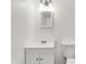 Bright bathroom featuring a white vanity, mirror, modern lighting, and toilet at 9157 Neptune Dr, Indianapolis, IN 46229