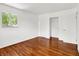 Bedroom featuring hardwood floors, white walls and trim, and a closet at 9157 Neptune Dr, Indianapolis, IN 46229