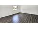 Bedroom featuring new gray wood-look flooring and a bright window at 9157 Neptune Dr, Indianapolis, IN 46229