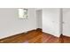 Bedroom with hardwood floors, closet, and a window for natural light at 9157 Neptune Dr, Indianapolis, IN 46229
