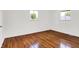 Bright bedroom featuring hardwood floors and two windows providing natural light at 9157 Neptune Dr, Indianapolis, IN 46229