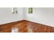 Bedroom with hardwood floors, white walls, white trim, and natural light from two windows at 9157 Neptune Dr, Indianapolis, IN 46229