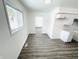 Open dining area with wood-look floors and view into kitchen at 9157 Neptune Dr, Indianapolis, IN 46229