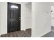 Clean entryway featuring a sleek black front door, modern flooring, and a convenient coat closet at 9157 Neptune Dr, Indianapolis, IN 46229