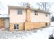 Side view of a ranch home with brick and siding exterior, showcasing a chimney at 9157 Neptune Dr, Indianapolis, IN 46229