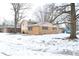 Side view of a ranch home with brick exterior and mature trees at 9157 Neptune Dr, Indianapolis, IN 46229