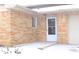 Front door and side view of a brick ranch home with a covered stoop at 9157 Neptune Dr, Indianapolis, IN 46229