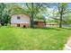 A two-story house with a brick base, siding, and a large grassy front yard at 9157 Neptune Dr, Indianapolis, IN 46229