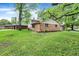 View of the house's exterior and yard, showcasing a brick facade and a well-maintained lawn at 9157 Neptune Dr, Indianapolis, IN 46229
