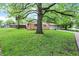A cozy home with a lush lawn and mature trees, nestled in a serene neighborhood setting at 9157 Neptune Dr, Indianapolis, IN 46229
