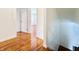 Hardwood floor hallway with doors to bedrooms and stairs at 9157 Neptune Dr, Indianapolis, IN 46229