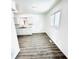 Bright kitchen with white cabinets, granite countertops, and grey wood-look floors at 9157 Neptune Dr, Indianapolis, IN 46229