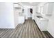 Modern kitchen featuring white cabinets and grey wood-look floors at 9157 Neptune Dr, Indianapolis, IN 46229
