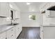 Bright kitchen featuring white cabinets, modern countertops, and stainless steel sink with stylish fixtures at 9157 Neptune Dr, Indianapolis, IN 46229