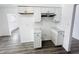 White kitchen cabinets, granite counters, and grey floors at 9157 Neptune Dr, Indianapolis, IN 46229