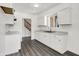 Updated kitchen with white cabinets, wood-look flooring and stairs, creating a bright, open space at 9157 Neptune Dr, Indianapolis, IN 46229