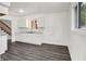 Eat-in kitchen with white cabinets, gray countertops, and new gray wood-look flooring at 9157 Neptune Dr, Indianapolis, IN 46229