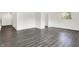 Open-concept living room featuring gray wood-look flooring and white walls at 9157 Neptune Dr, Indianapolis, IN 46229