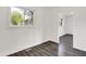 Bright living room featuring new gray wood-look flooring and large windows at 9157 Neptune Dr, Indianapolis, IN 46229