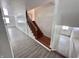 Interior view of a staircase with wood railing and gray vinyl flooring at 9157 Neptune Dr, Indianapolis, IN 46229