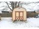 Tan shed with double doors in backyard, covered in snow at 9157 Neptune Dr, Indianapolis, IN 46229