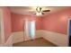 Bedroom with pink walls, white trim, ceiling fan, and window at 9915 N County Road 650 E, Pittsboro, IN 46167