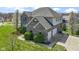 Gorgeous aerial view of a brick two-story home with a wide driveway and an attached three-car garage at 11383 Sea Side Ct, Fishers, IN 46040