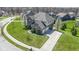Beautiful aerial view of a two-story brick home with a wide driveway and well-manicured landscaping at 11383 Sea Side Ct, Fishers, IN 46040
