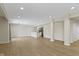 Finished basement featuring light wood floors, recessed lighting, and a bar at 11383 Sea Side Ct, Fishers, IN 46040