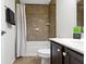 This bathroom offers a shower and tub combo, dark vanity with white countertop, and tile at 11383 Sea Side Ct, Fishers, IN 46040
