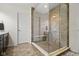 Bathroom featuring a glass-enclosed shower with tiled walls and floors at 11383 Sea Side Ct, Fishers, IN 46040