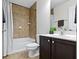 This bathroom offers a shower and tub combo, dark vanity with white countertop, and tile at 11383 Sea Side Ct, Fishers, IN 46040
