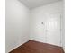 An empty bedroom featuring laminate flooring, a white door, and a thermostat at 11383 Sea Side Ct, Fishers, IN 46040