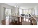 Open dining area with hardwood floors, ample light, and view to living room at 11383 Sea Side Ct, Fishers, IN 46040