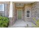 Inviting front porch with a olive green door and decorative brickwork at 11383 Sea Side Ct, Fishers, IN 46040
