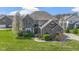 Beautiful two-story brick home with manicured lawn and sidewalks surrounded by mature, blooming trees at 11383 Sea Side Ct, Fishers, IN 46040