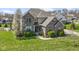 Attractive two-story brick home with manicured lawn and sidewalk, surrounded by mature trees in full bloom at 11383 Sea Side Ct, Fishers, IN 46040