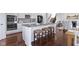 Kitchen island with granite countertops, white cabinets, and woven stools at 11383 Sea Side Ct, Fishers, IN 46040