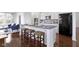 Kitchen island with granite countertops, white cabinets, and woven stools at 11383 Sea Side Ct, Fishers, IN 46040