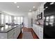 Bright kitchen featuring white cabinets, stainless steel appliances, and a granite countertop at 11383 Sea Side Ct, Fishers, IN 46040