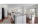 Open-concept kitchen and dining area with white cabinets and stainless-steel appliances at 11383 Sea Side Ct, Fishers, IN 46040