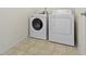 The laundry room features a new washer and dryer, and modern tile flooring at 11383 Sea Side Ct, Fishers, IN 46040