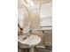 Bathroom featuring a white pedestal sink, an oval mirror, and a window at 1319 N New Jersey St, Indianapolis, IN 46202