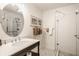 Bright bathroom featuring a glass shower, oval mirror, and decorative accents creating a spa-like atmosphere at 1319 N New Jersey St, Indianapolis, IN 46202